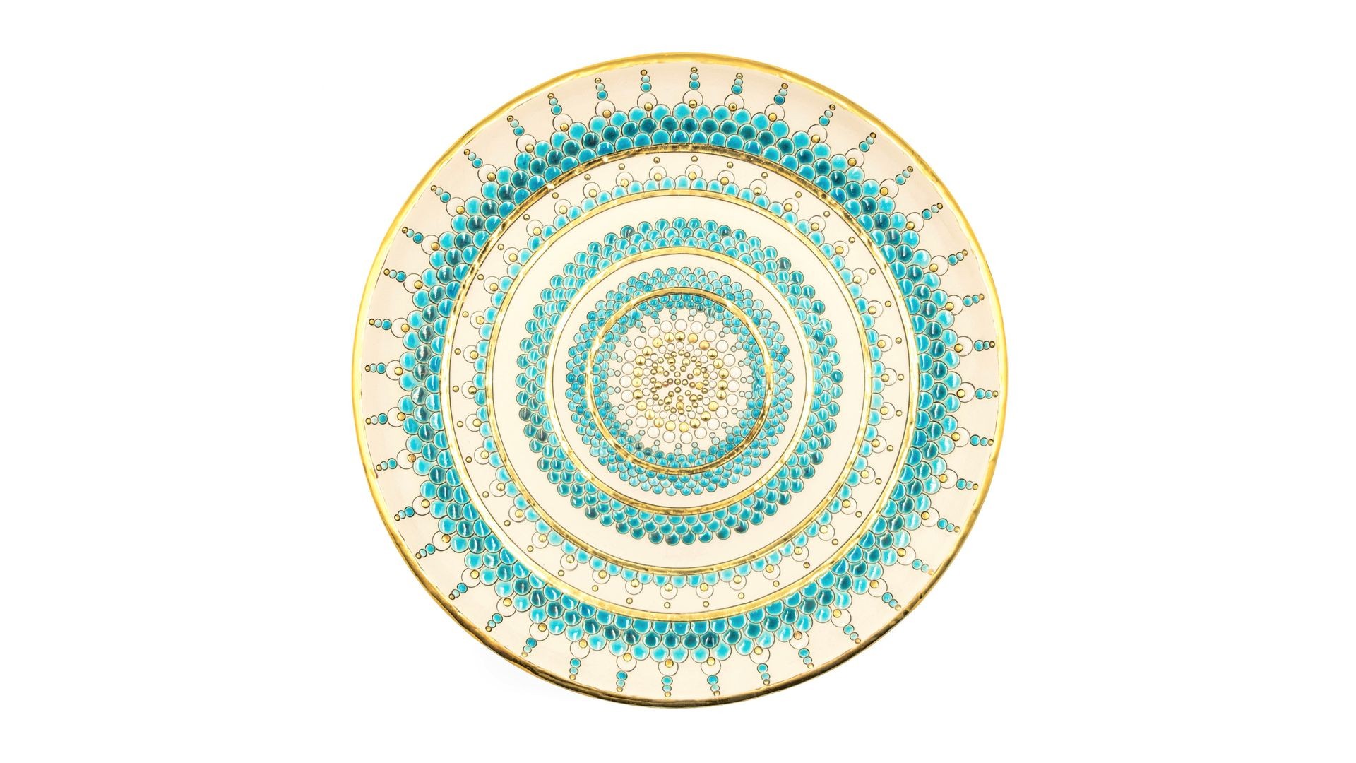 Top-view of a decorative plate with intricate blue and gold circular patterns on a white background.